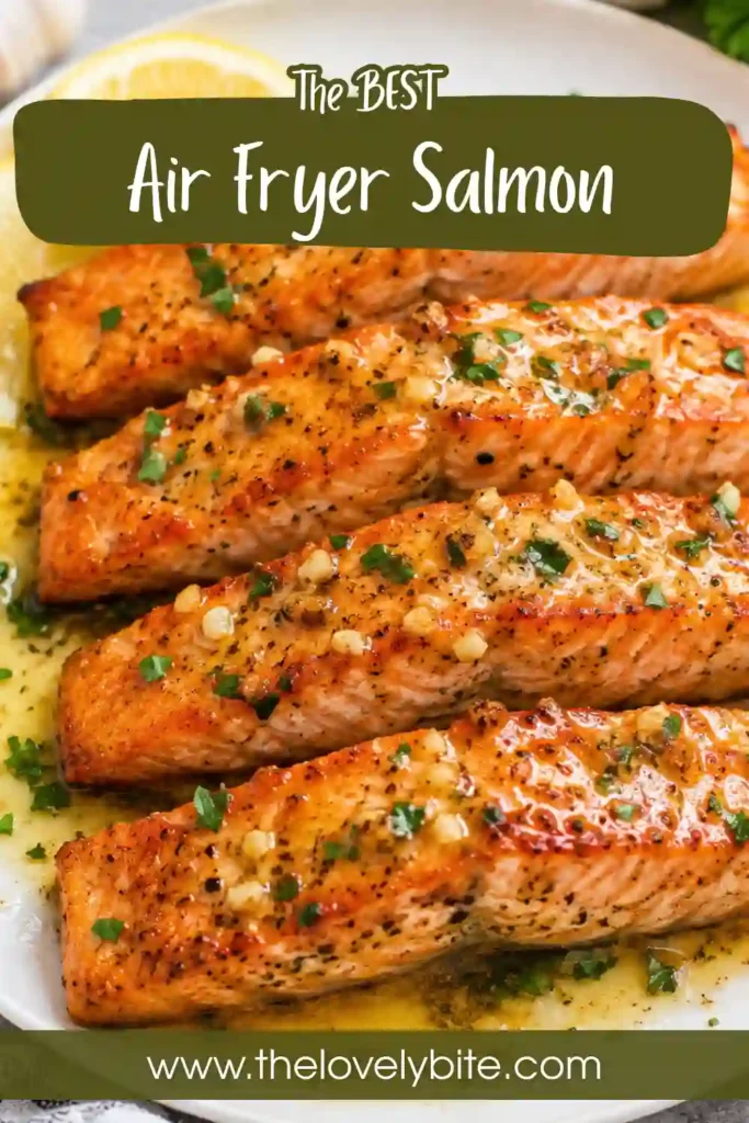 Perfectly cooked Air Fryer Salmon with fresh lemon and garlic butter served on a dinner plate. A quick and healthy salmon recipe.