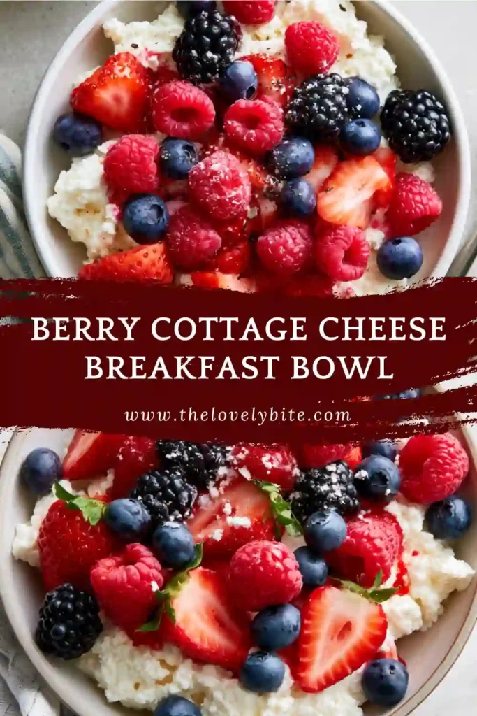 Cottage cheese bowl topped with berries, almonds, and a drizzle of honey.