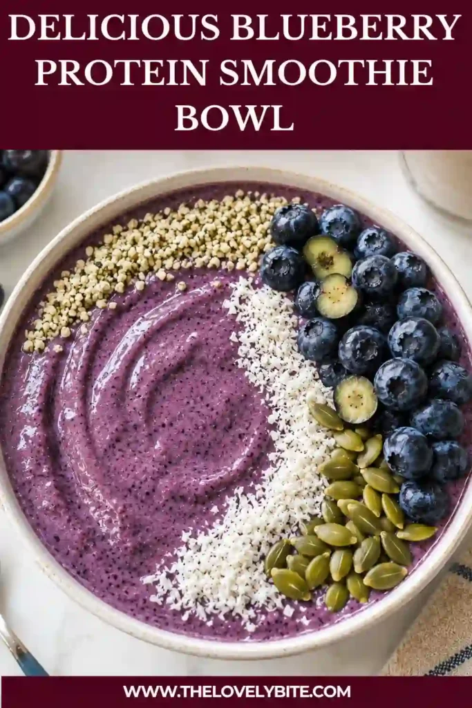 A vibrant blueberry smoothie bowl served in a white bowl with nutritious toppings including coconut, pumpkin seeds, and fresh blueberries. Perfect for a healthy morning meal.