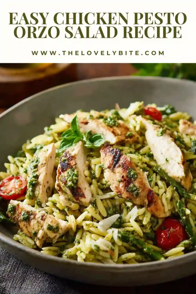 A close-up view of Chicken Pesto Orzo Salad with juicy chicken slices, lemon herb pesto, asparagus, and tender pasta. Ideal for meal prep, lunch, or dinner.