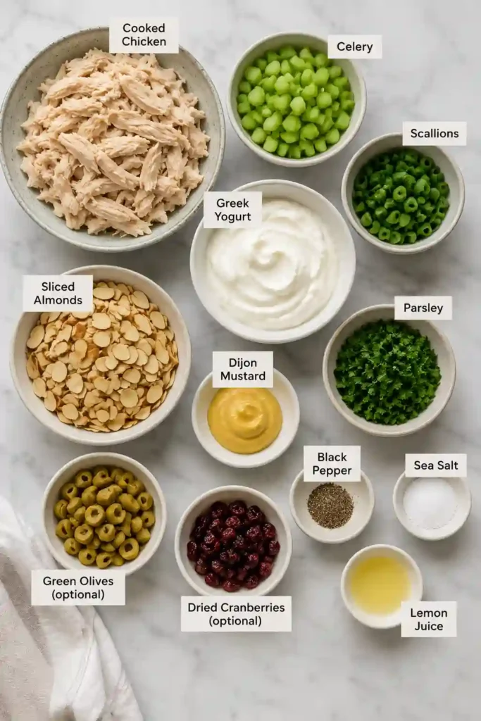 A bowl of healthy chicken salad made with shredded chicken, Greek yogurt, celery, parsley, and toasted almonds. This high-protein lunch recipe looks fresh, creamy, and satisfying.