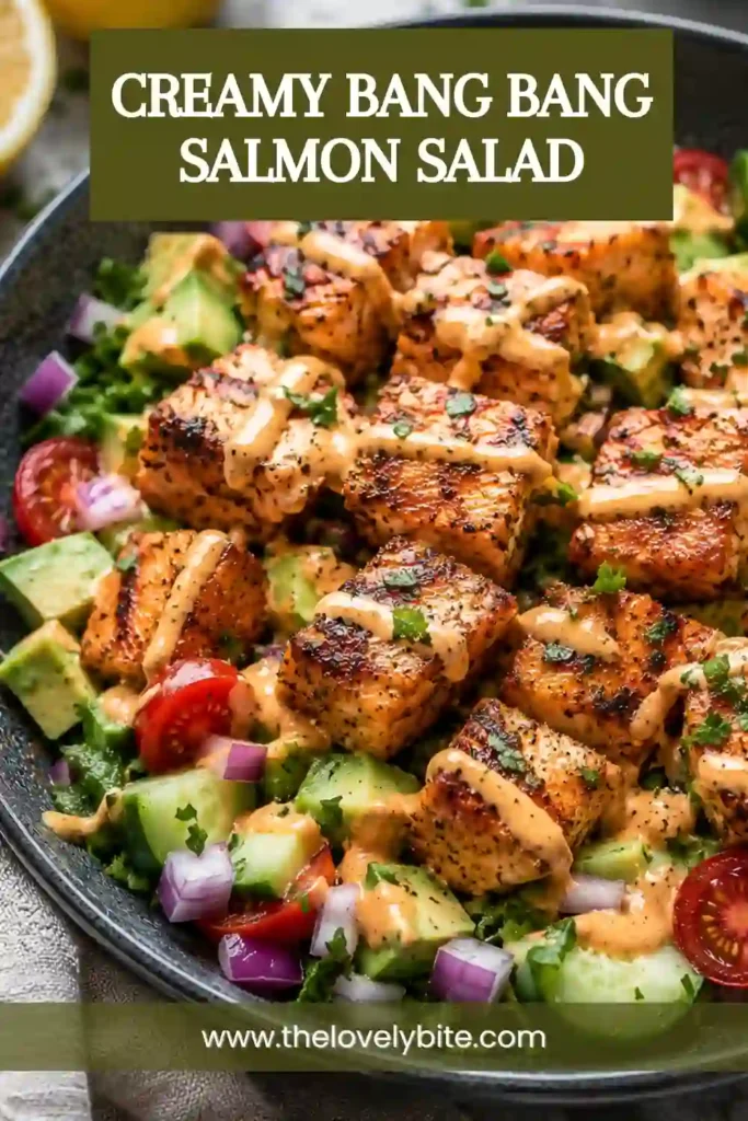 Close-up of Creamy Bang Bang Salmon Salad featuring flaky salmon, avocado chunks, fresh herbs, and spicy bang bang dressing. A nutritious and satisfying meal option.