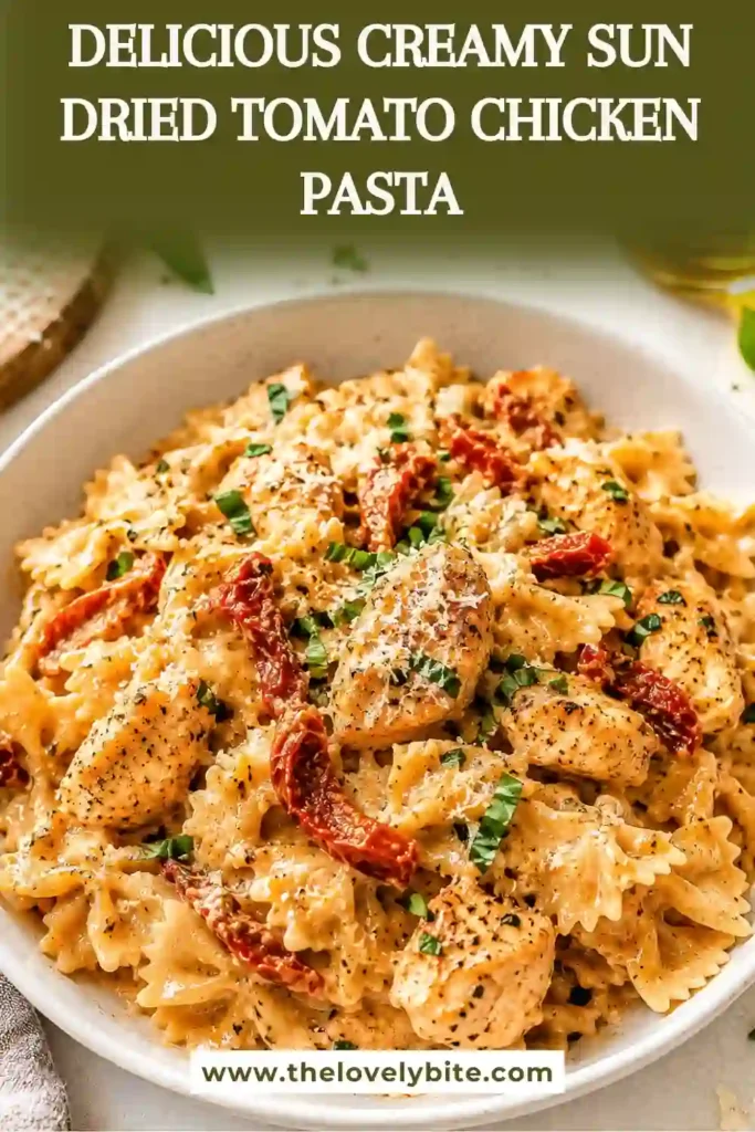 A bowl of Creamy Sun Dried Tomato Chicken Pasta topped with freshly grated parmesan cheese and baby spinach. The rich cream sauce coats every piece of pasta and tender chicken for a comforting dinner.