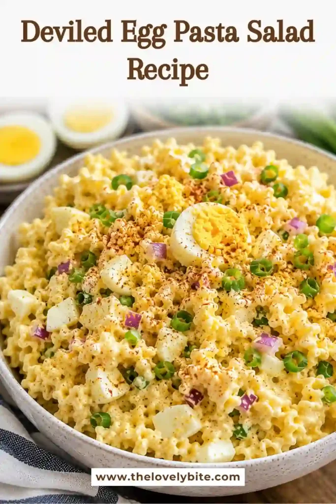 Homemade Deviled Egg Pasta Salad served in a white bowl with fresh green onion garnish. This easy cold pasta salad is perfect for picnics and summer gatherings.