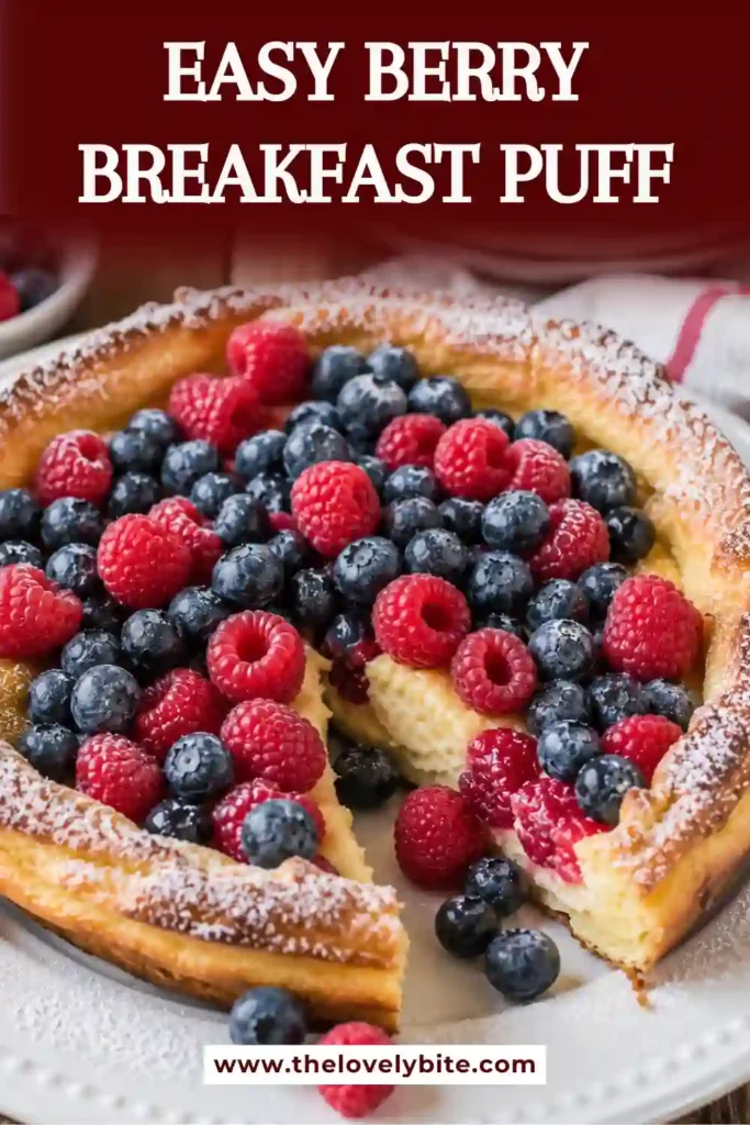 Golden brown berry breakfast puff baked in a skillet and finished with fresh mixed berries and a dusting of powdered sugar. A perfect brunch centerpiece.