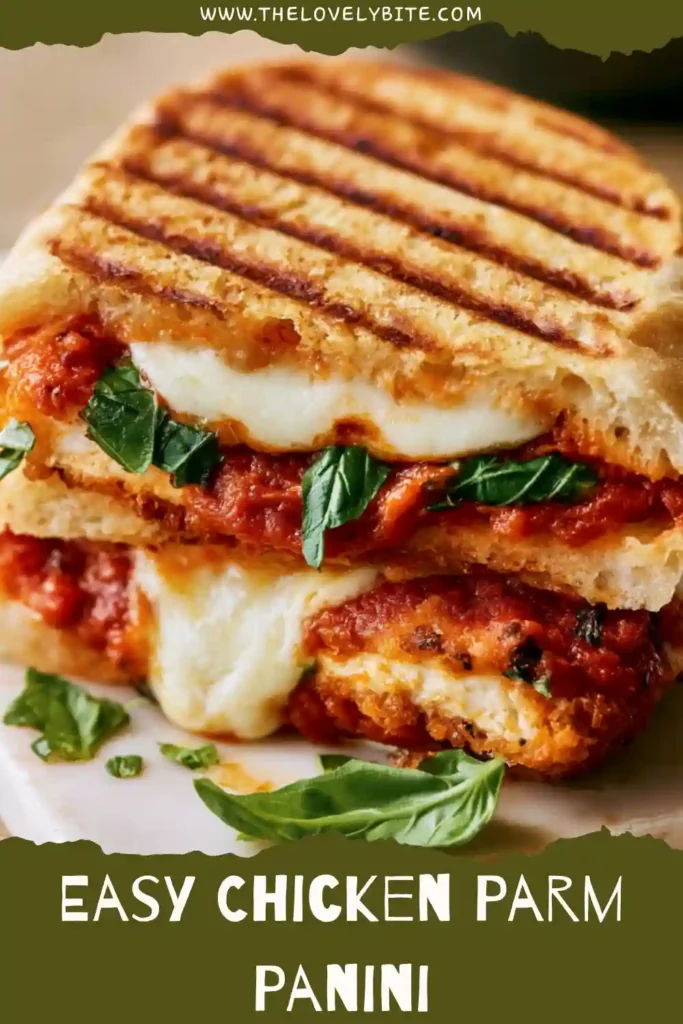 A crispy Chicken Parm Panini filled with grilled chicken, marinara sauce, and melted mozzarella cheese. The sandwich is grilled until golden brown and served hot with extra sauce.