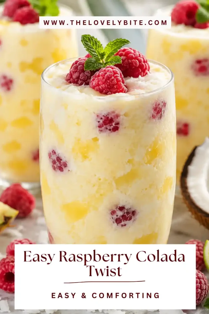 Homemade Easy Raspberry Colada Twist Recipe featuring fresh fruit and coconut cream. The vibrant pink tropical drink is served cold with mint garnish.