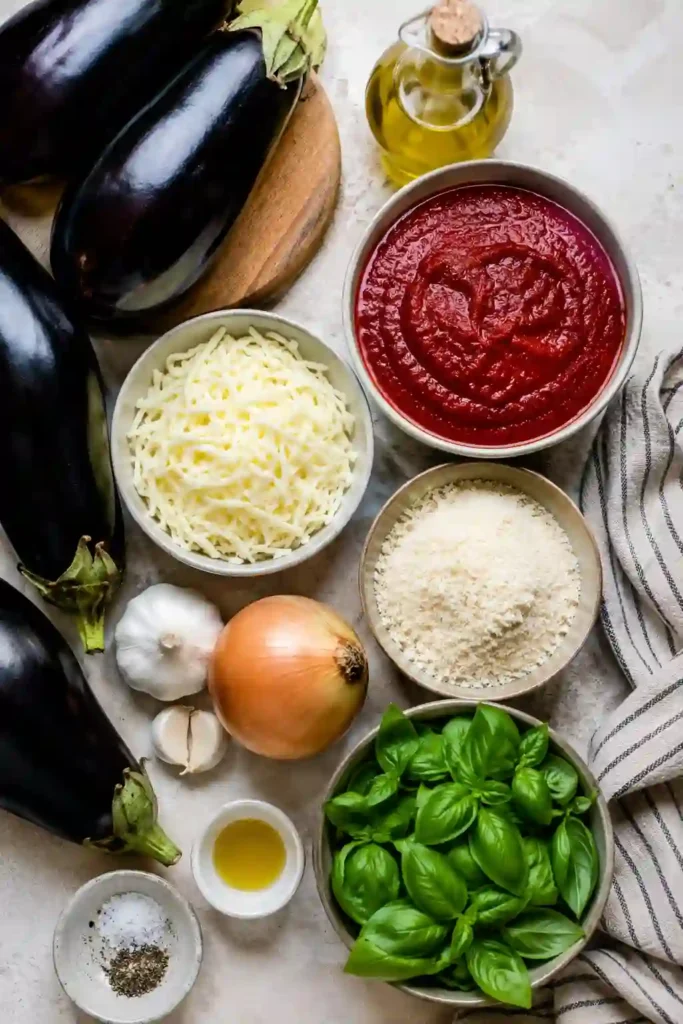 Freshly baked Eggplant Parmigiana layered with roasted eggplant, tomato sauce, mozzarella, and parmesan cheese. The casserole is golden, bubbly, and garnished with fresh basil.