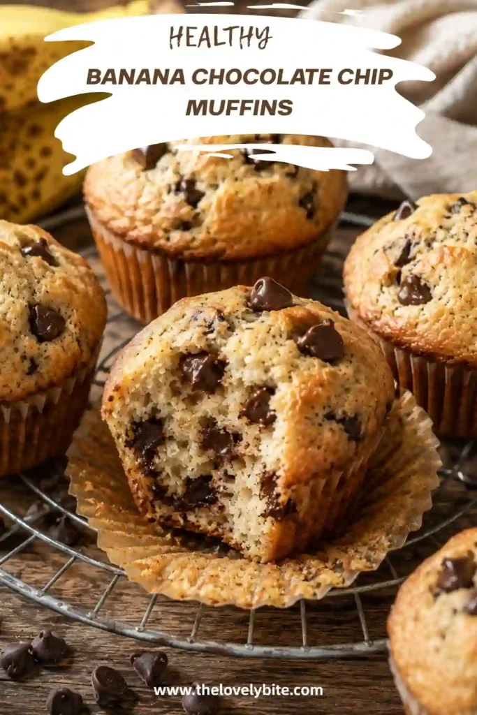 Freshly baked Healthy Banana Chocolate Chip Muffins cooling on a wire rack with melted chocolate chips visible throughout. These whole wheat banana muffins are moist, fluffy, and perfect for breakfast.