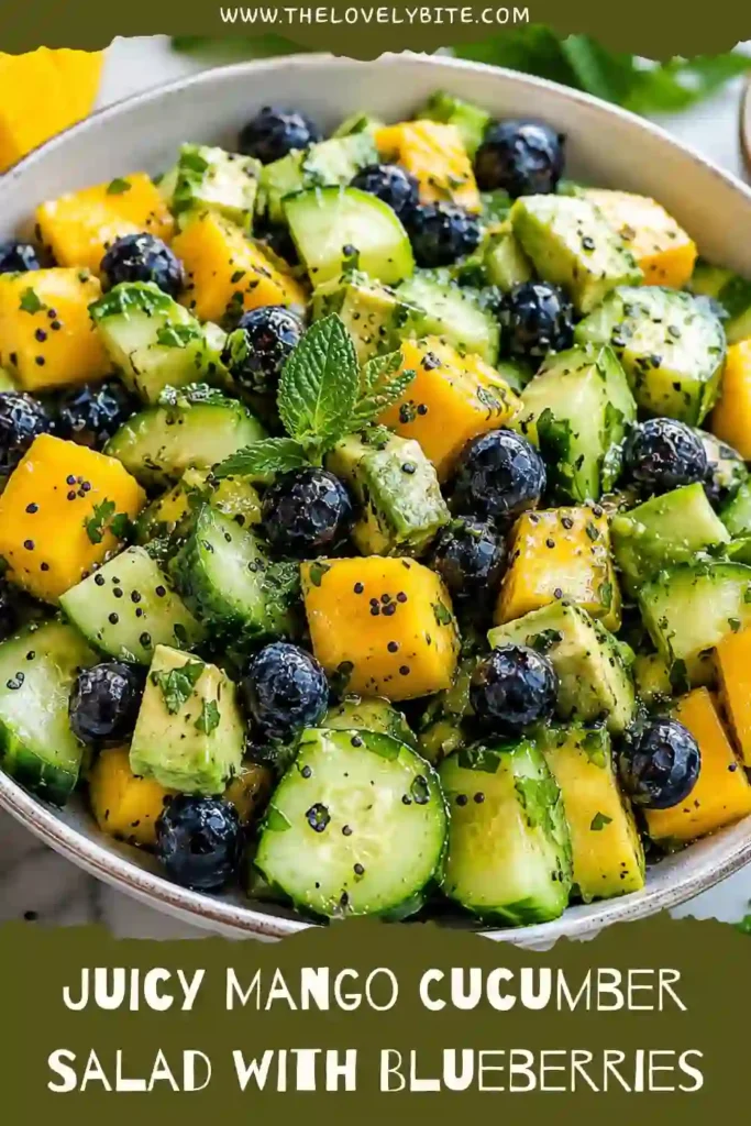 A healthy fruit and cucumber salad made with mango, avocado, blueberries, and fresh cilantro. The salad is lightly dressed with lime and olive oil for a refreshing finish.