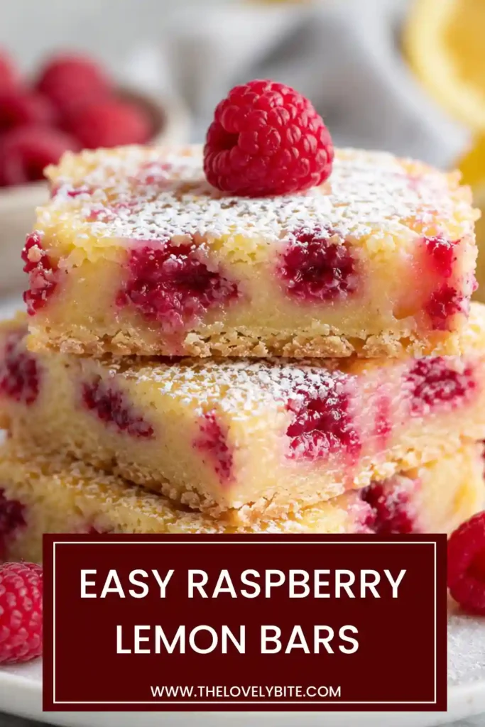 Close-up of Raspberry Lemon Bars showing layers of buttery crust and tangy raspberry lemon filling. Powdered sugar adds a delicate finishing touch.