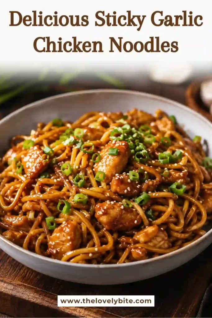 Close-up of garlic chicken noodles tossed in a sticky honey soy glaze. Fresh spring onions and sesame seeds add color and texture.