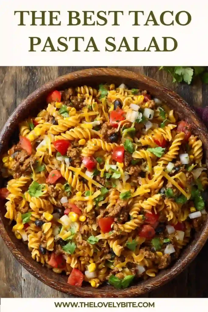 Fresh Taco Pasta Salad topped with crushed Doritos, cheddar cheese, and diced vegetables. A hearty Mexican-inspired pasta salad made with seasoned beef and Catalina dressing.