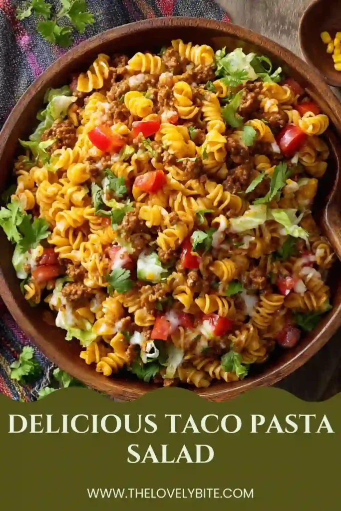 Tex-Mex Taco Pasta Salad served in a large bowl with fresh vegetables, cheddar cheese, and crunchy tortilla chips. A delicious and colorful potluck favorite.