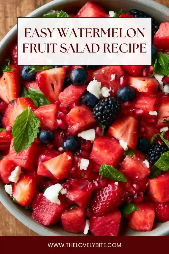 A bowl of watermelon berry salad with strawberries, blueberries, blackberries, and fresh mint. The fruit is tossed in a sweet and tangy lime dressing.