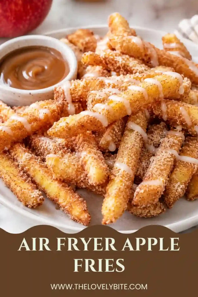 Freshly cooked crispy apple fries made in the air fryer and sprinkled with cinnamon sugar. The warm apple sticks have a golden breadcrumb coating and are served with whipped cream.