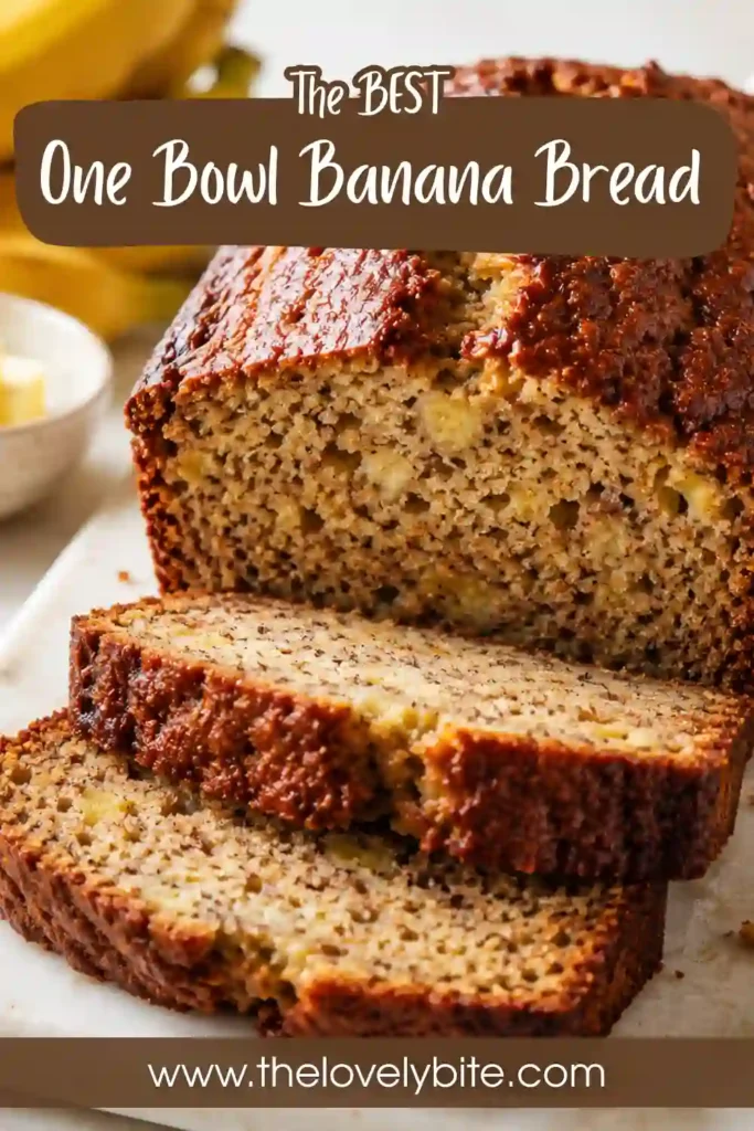A loaf of banana bread with yogurt cooling on a wire rack after baking until golden brown. The moist crumb makes it a delicious homemade treat.