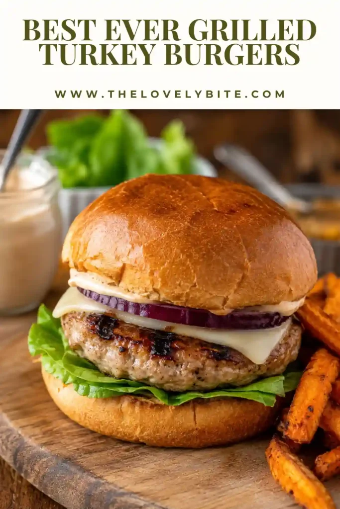 2. Homemade grilled turkey burgers topped with melted cheddar cheese and fresh vegetables on a serving platter.