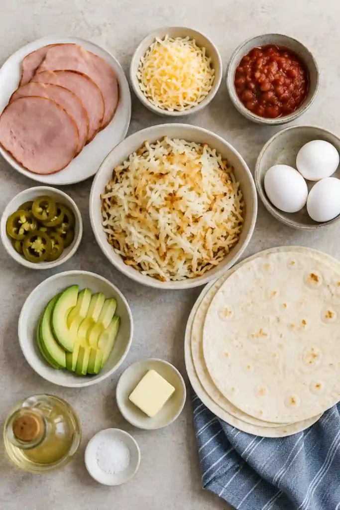 Cheesy Breakfast Burritos served warm with salsa and avocado on the side. An easy homemade breakfast wrap that's filling and flavorful.