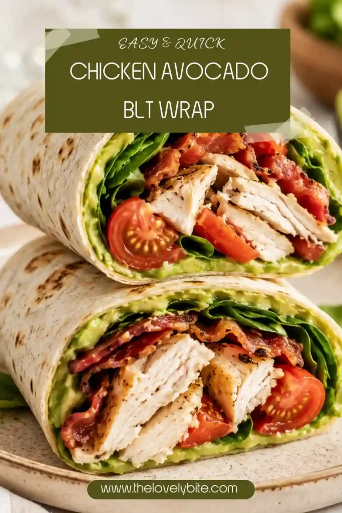 Whole wheat Chicken Avocado BLT Wrap cut in half to reveal layers of chicken, guacamole, tomatoes, spinach, and crispy turkey bacon. Served fresh on a plate.