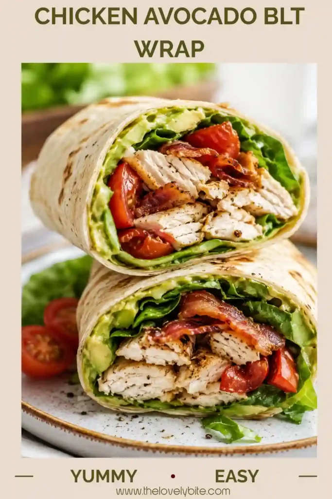 Healthy Chicken Avocado BLT Wrap filled with lean chicken, avocado spread, spinach, tomatoes, and turkey bacon on a serving plate with grapes.