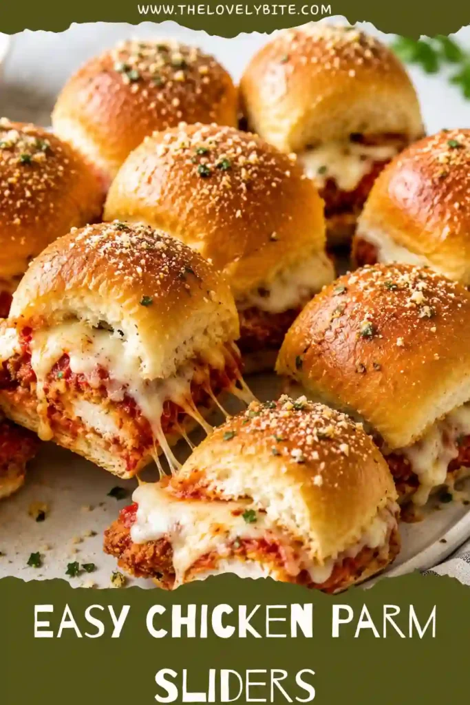 Close-up of cheesy Chicken Parm Sliders topped with garlic butter and Pecorino Romano cheese. Soft Hawaiian rolls surround crispy chicken and savory marinara.