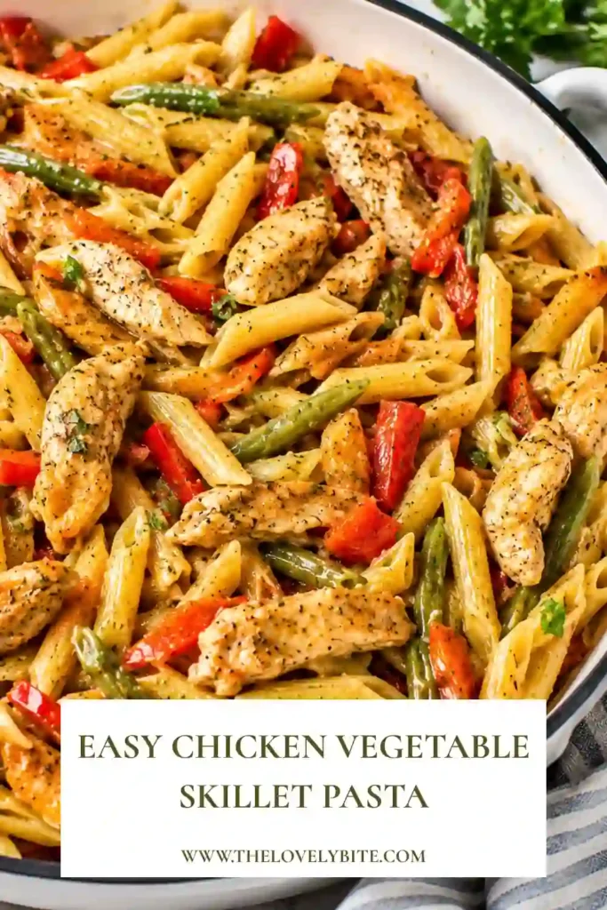A bowl of Chicken Vegetable Skillet Pasta made with tender chicken strips, colorful bell peppers, and penne pasta tossed in a light balsamic lemon sauce. Fresh parsley adds a bright finishing touch.