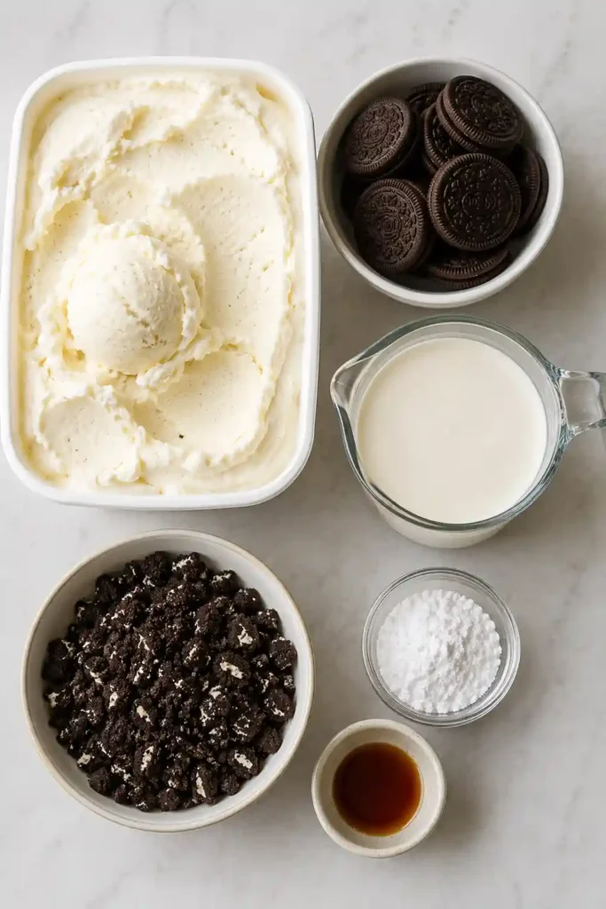 Cookies and Cream Ice Cream Cake topped with fluffy whipped cream and crushed chocolate sandwich cookies. This creamy frozen dessert features beautiful layered textures that make it perfect for celebrations.
