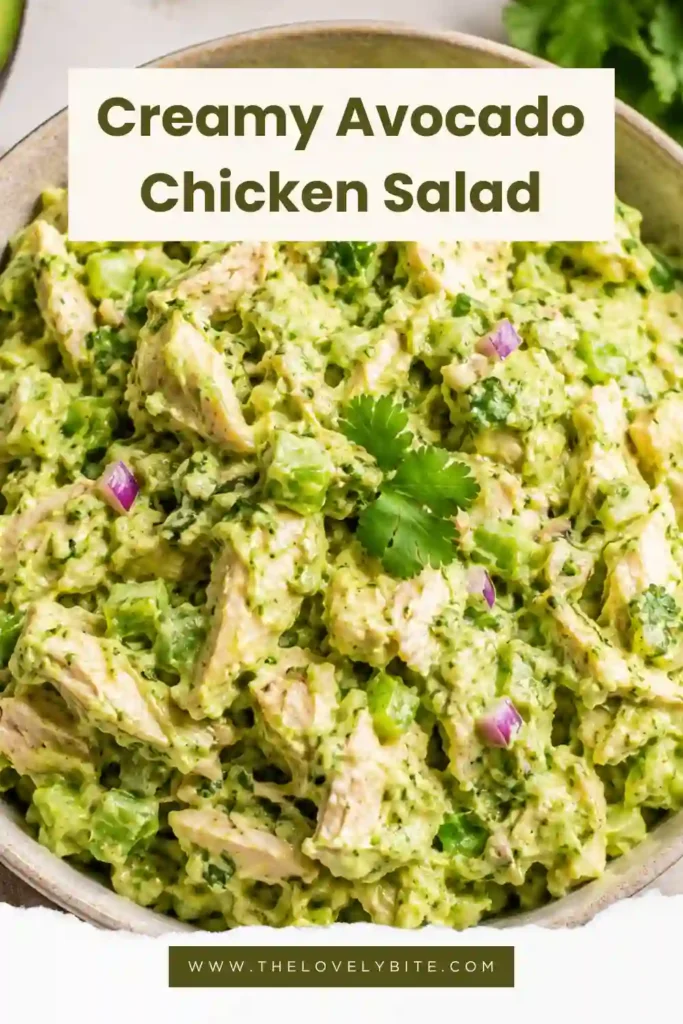 Close-up of homemade avocado chicken salad with diced avocado, shredded chicken, celery, and fresh herbs in a creamy dressing.