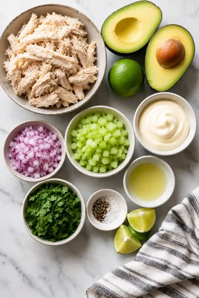 Creamy avocado chicken salad served with crackers and lettuce leaves for a fresh and satisfying meal.