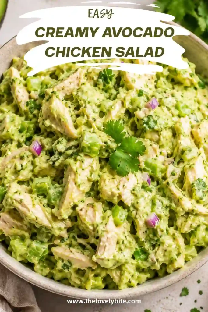 A bowl of Creamy Avocado Chicken Salad made with shredded chicken, diced avocado, celery, onion, cilantro, and fresh lime juice. The salad has a creamy texture and is garnished with extra cilantro.