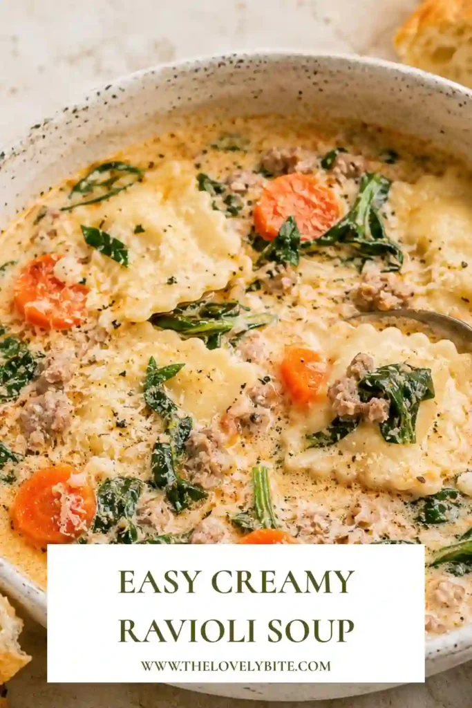 A bowl of Creamy Ravioli Soup filled with cheese ravioli, fresh spinach, carrots, and ground turkey in a rich tomato cream broth. Garnished with grated Parmesan for a comforting homemade meal.