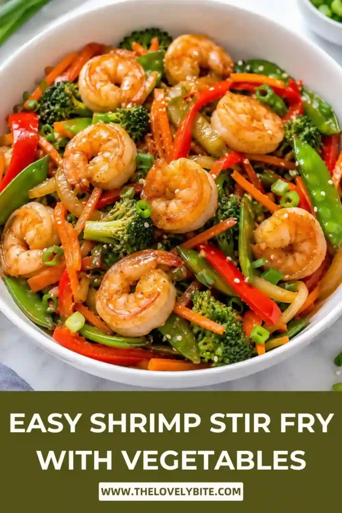 A bowl of Easy Shrimp Stir Fry filled with juicy shrimp, colorful vegetables, and glossy homemade stir fry sauce served over steamed rice. The meal looks fresh, vibrant, and healthy.