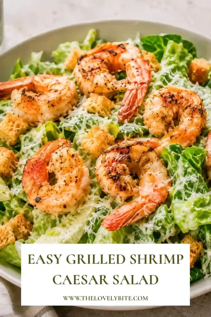 A bowl of Grilled Shrimp Caesar Salad topped with juicy grilled shrimp, crisp romaine lettuce, freshly grated Parmesan cheese, and crunchy seasoned breadcrumbs. This fresh salad is perfect for a healthy summer meal.