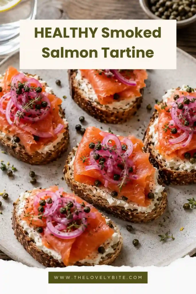 Rustic smoked salmon tartines arranged on a serving board with herbs, crispy capers, and toasted bread.
