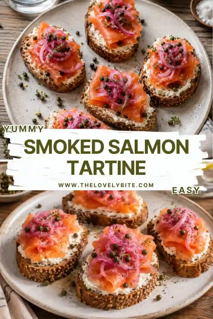 Open-faced smoked salmon sandwich topped with dill, chives, thyme, and crispy capers on toasted seeded bread.