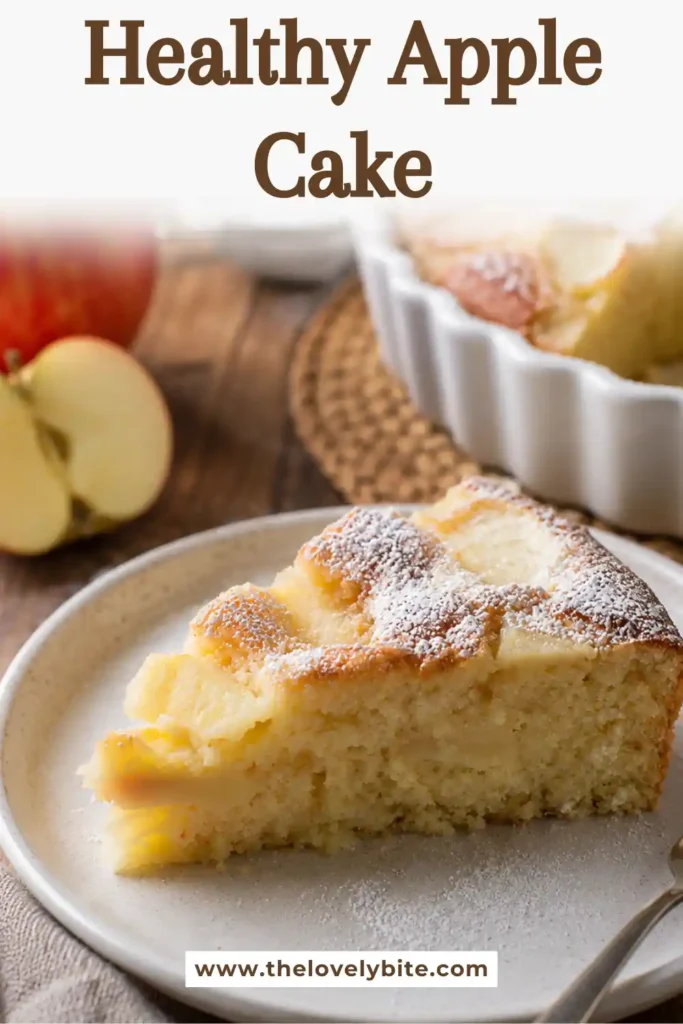 Healthy Apple Cake topped with thinly sliced baked apples and lightly dusted with powdered sugar. A soft homemade apple cake made with fresh fruit and simple ingredients.