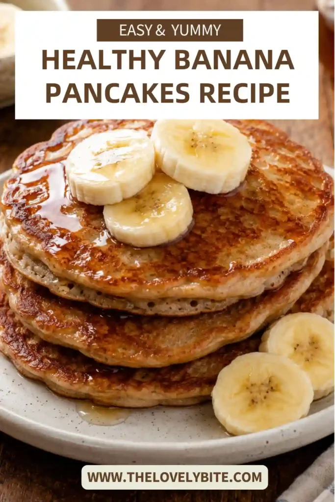 Soft homemade banana pancakes made with Greek yogurt and whole wheat flour, stacked high and garnished with fresh fruit.