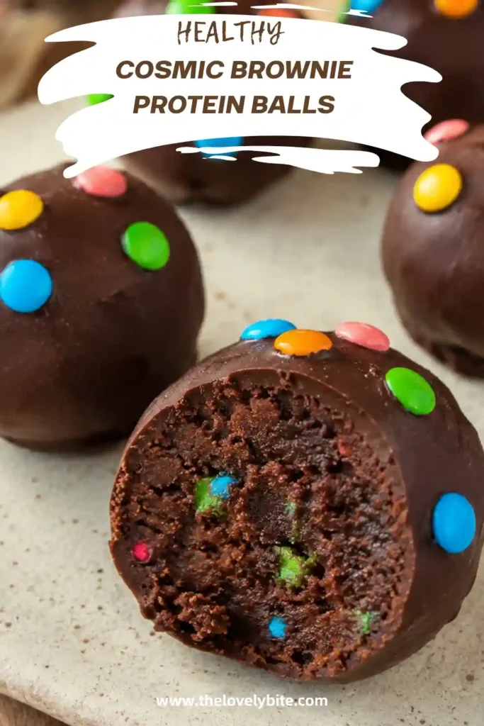 A plate of Healthy Cosmic Brownie Protein Balls with a smooth chocolate coating and festive sprinkles. These no bake protein balls are packed with chocolate flavor and wholesome ingredients.