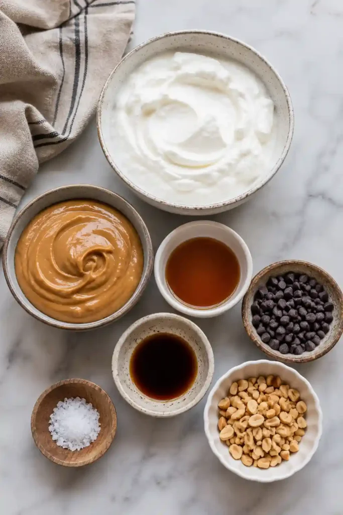 Creamy frozen peanut butter yogurt bites made with Greek yogurt and topped with chocolate chips. An easy healthy dessert that's rich in protein and freezer-friendly.