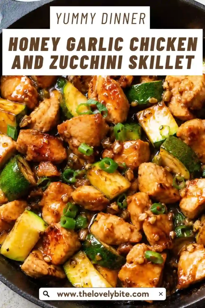 A skillet filled with Honey Garlic Chicken and Zucchini featuring golden chicken pieces coated in a glossy honey garlic sauce with tender zucchini and fresh scallions. This easy one pan chicken dinner is colorful and perfect for busy weeknights.