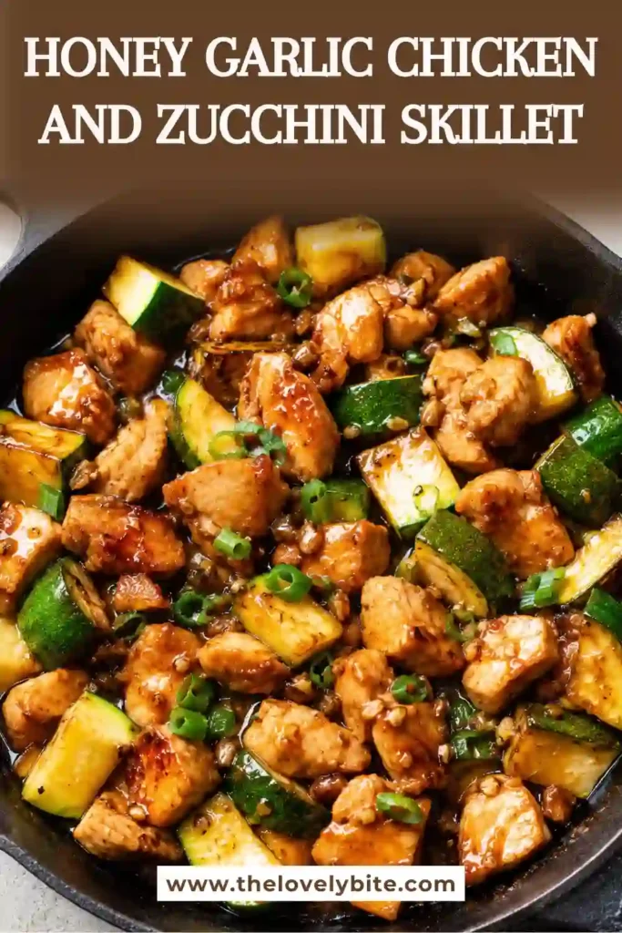 Close-up of Honey Garlic Chicken and Zucchini Skillet served in a cast-iron pan with caramelized chicken, fresh zucchini, garlic, and sliced scallions. The rich honey garlic glaze creates a delicious family-friendly meal.