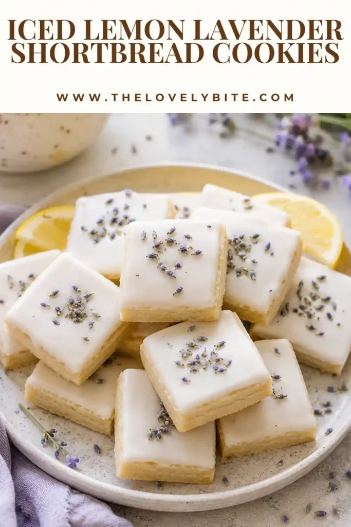 Buttery lemon lavender shortbread cookies decorated with glossy icing and edible lavender buds.