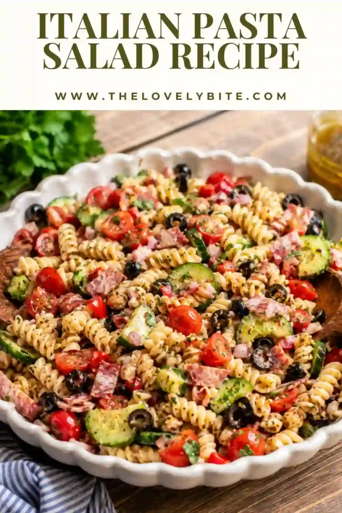 Easy homemade pasta salad featuring rotini, fresh vegetables, olives, turkey salami, chicken, and a tangy Italian vinaigrette.
