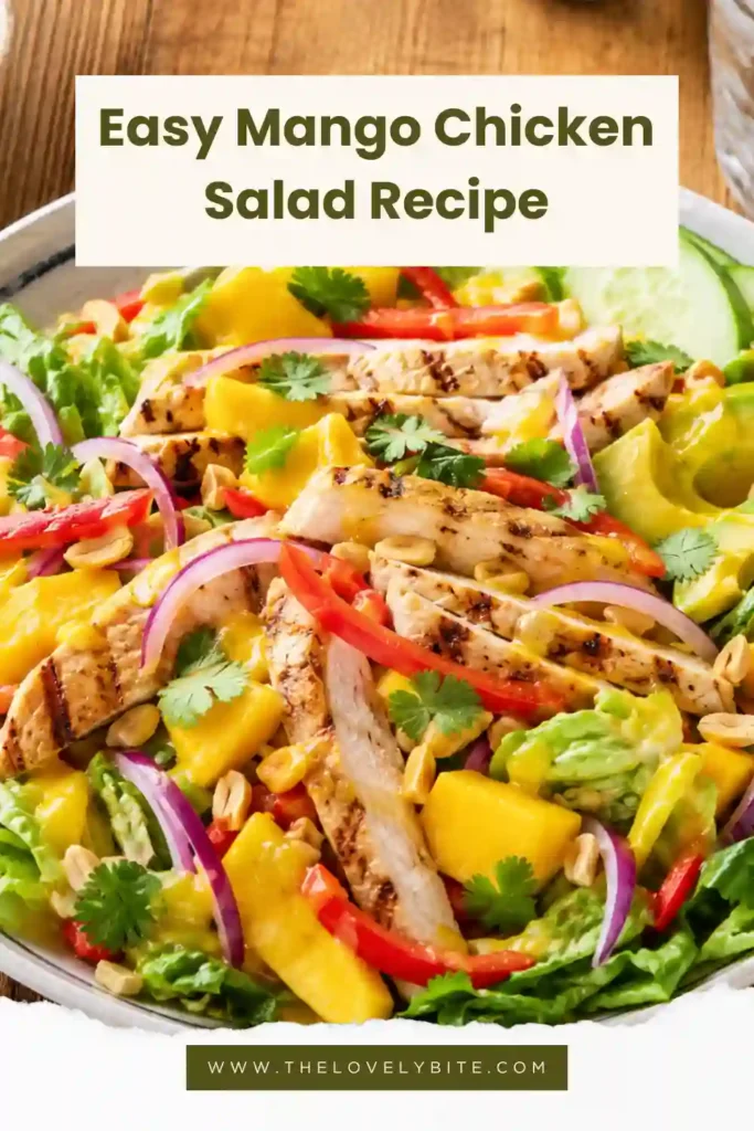 Fresh tropical chicken salad featuring mango, avocado, bell peppers, mixed greens, herbs, and roasted peanuts for a vibrant meal.