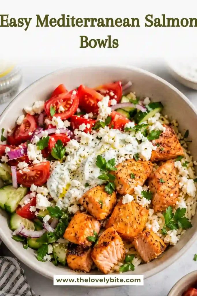 Homemade Mediterranean Salmon Bowls with seasoned salmon, fresh vegetables, rice, feta, and herb yogurt sauce arranged in a serving bowl. A delicious Greek-inspired salmon and rice bowl.