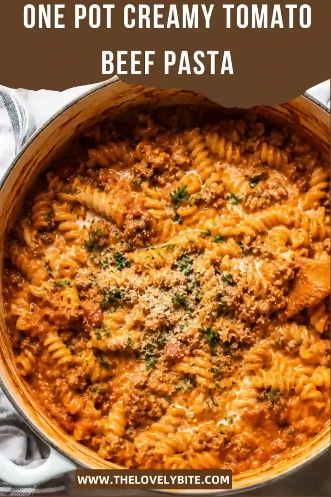 Creamy tomato beef pasta served warm in a rustic bowl with Parmesan cheese and fresh parsley. This comforting one-pot pasta is perfect for easy family dinners.