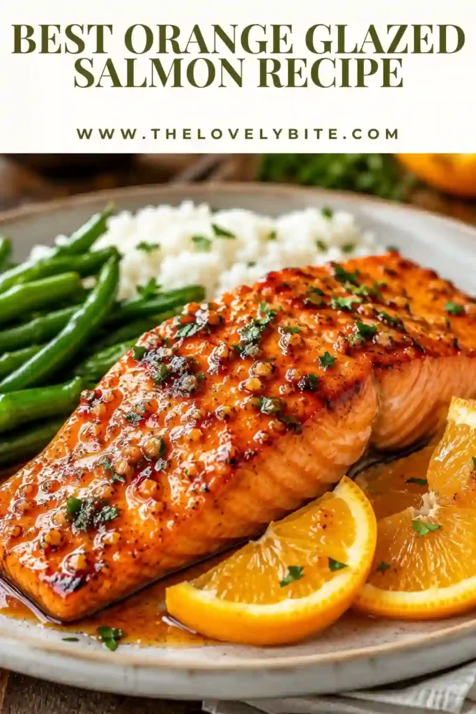 Orange Glazed Salmon served in a skillet with a glossy honey citrus sauce and fresh orange slices. The pan seared salmon is tender, flaky, and garnished for a vibrant dinner presentation.