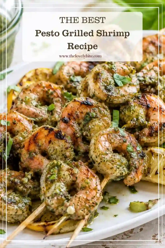 Close-up of grilled shrimp skewers finished with basil pesto and fresh basil. This easy pesto grilled shrimp recipe is packed with fresh Mediterranean-inspired flavors.