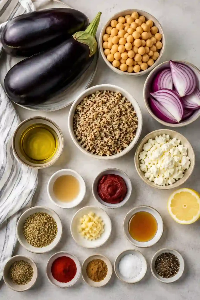 A healthy chickpea quinoa bowl topped with roasted vegetables, creamy feta, and fresh herbs. This roasted eggplant recipe is ideal for meal prep and weeknight dinners.